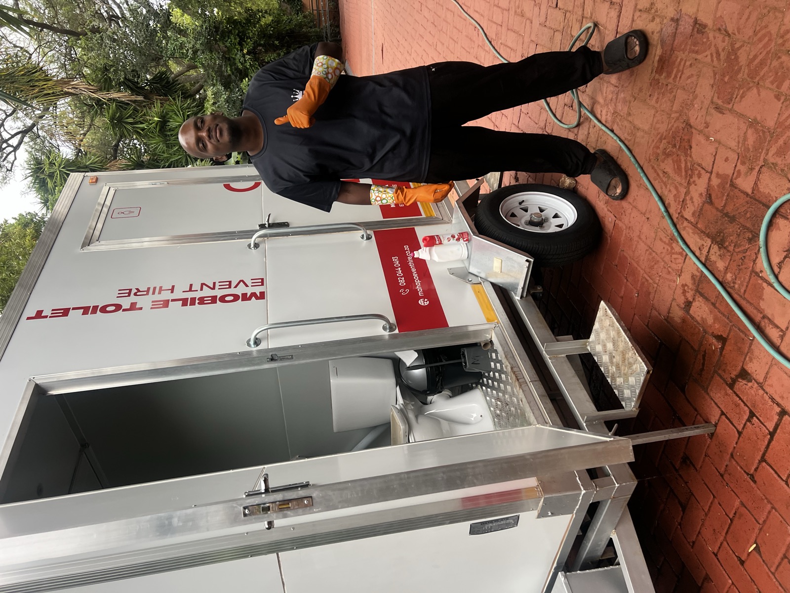 Me on-site cleaning a mobile toilet for Mahapa Event Hire